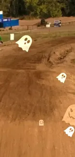 Dirt bike on rugged track with animated ghosts floating.