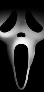 Ghostly mask on black background wallpaper.