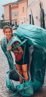 Person with giant teal backpack in a city setting.