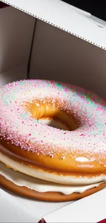 Colorful giant donut in a box with pink sprinkles, perfect for dessert lovers.