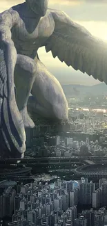 Giant winged statue overlooking a cityscape at sunset.