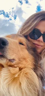 Girl and fluffy dog enjoying a sunny day with blue sky.