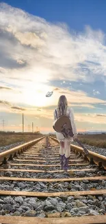 Girl walking on railway tracks at sunset with a vibrant, cloudy sky.