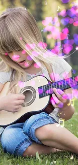 A young girl sitting on grass strumming a guitar.