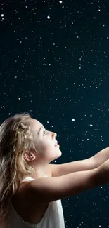 Girl reaching out to a starry sky background.