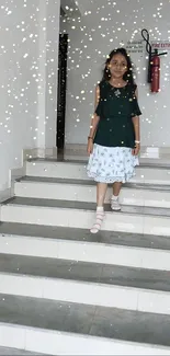 Girl in green top descending stairs with sparkles.