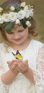 Girl in lace dress with floral crown holds a butterfly.