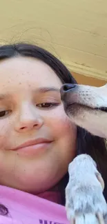 Smiling girl with her dog in a close-up shot.