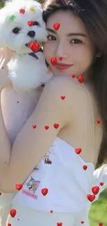 Girl holds fluffy white dog in a sunny outdoor setting, capturing a joyful moment.