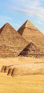 Giza pyramids and Great Sphinx under blue sky in the Egyptian desert.