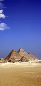 Majestic Giza pyramids under a vibrant blue sky.