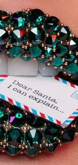 Crystal-studded lips holding a note with teal accents.