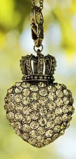 Diamond-studded heart pendant with crown on elegant wallpaper.