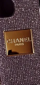 Luxurious phone case with diamond and gold design.