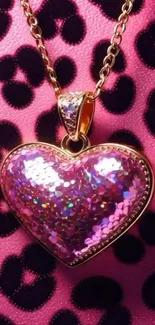 Heart-shaped pendant on pink leopard print background.