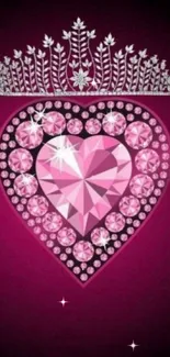 Pink heart wallpaper with a crown and sparkling jewels on dark background.