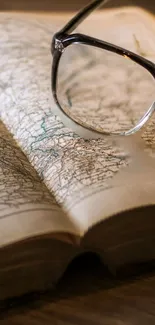 Glasses resting on an open map with warm brown tones.