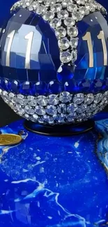 Blue gemstone orb with crystals on a luxurious background.