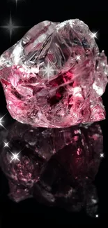 Gleaming pink gemstone on black background with reflection.