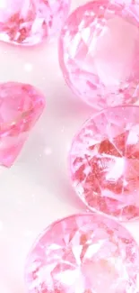 Glistening pink gemstones on a white surface, offering elegance and sparkle.