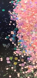 Colorful glitter particles on black background, vibrant phone wallpaper.