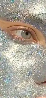 Close-up of a face covered in shimmering silver glitter.