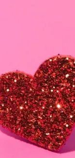 Glittery red heart on a pink background wallpaper.