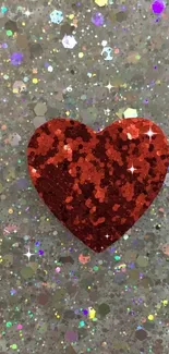 Red glitter heart with shimmering confetti background.