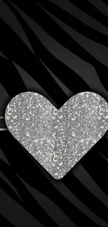 Glittery heart with zebra stripes on a black background.