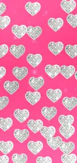 Sparkling glitter hearts on pink wallpaper background.