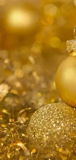 Golden ornaments surrounded by glitter, perfect for festive mobile wallpaper.