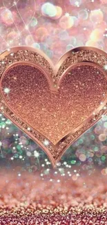 Rose gold glitter heart with sparkling bokeh background on wallpaper.