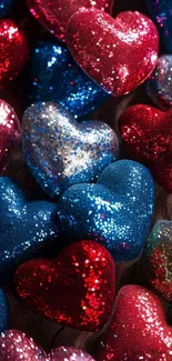 Sparkling red and blue glitter hearts clustered together.
