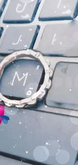 Sparkling ring on keyboard with heart accents, perfect mobile wallpaper.