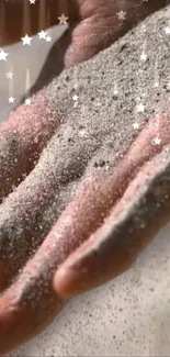 Close-up of a hand holding sparkling sand with starry glitter.