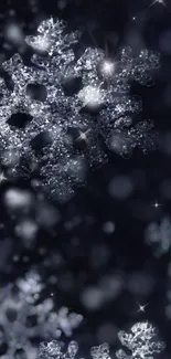 Glittering snowflake wallpaper with dark blue tones.