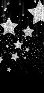 Silver glitter stars on black background wallpaper.