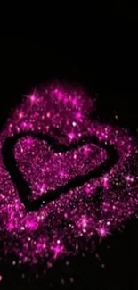 Glittery pink heart against black background.