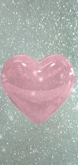 Glittery pink heart on teal background wallpaper.