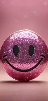 Pink glittery smiley face against pink background.