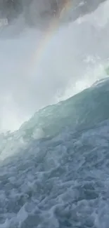 Waterfall cascading with a rainbow in mist.