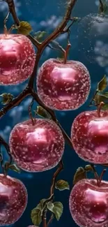 Glossy red apples on branch with blue background.