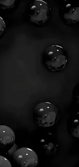 Glossy black spheres on a dark background wallpaper.