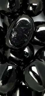 Glossy black gemstones arranged closely together.