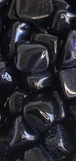 Glossy black stones with a polished surface for a sleek wallpaper.