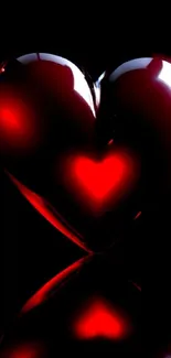 Glossy red heart on black background with a shiny effect.