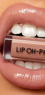 Close-up of glossy lips with a nude gloss tube.