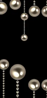 Mobile wallpaper with glossy pearl beads on black background.