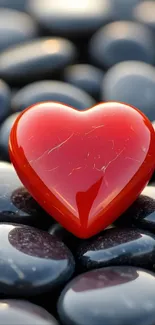 Glossy red heart on smooth black stones.