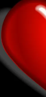 Glossy 3D red heart on black background mobile wallpaper